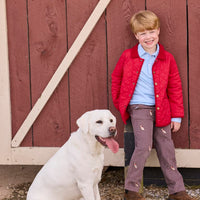 Little English traditional children's clothing.  Classic long sleeve light blue polo and chocolate brown corduroy pants with seated lab embroidery for boys. Layered with red quilted jacket with corduroy details.