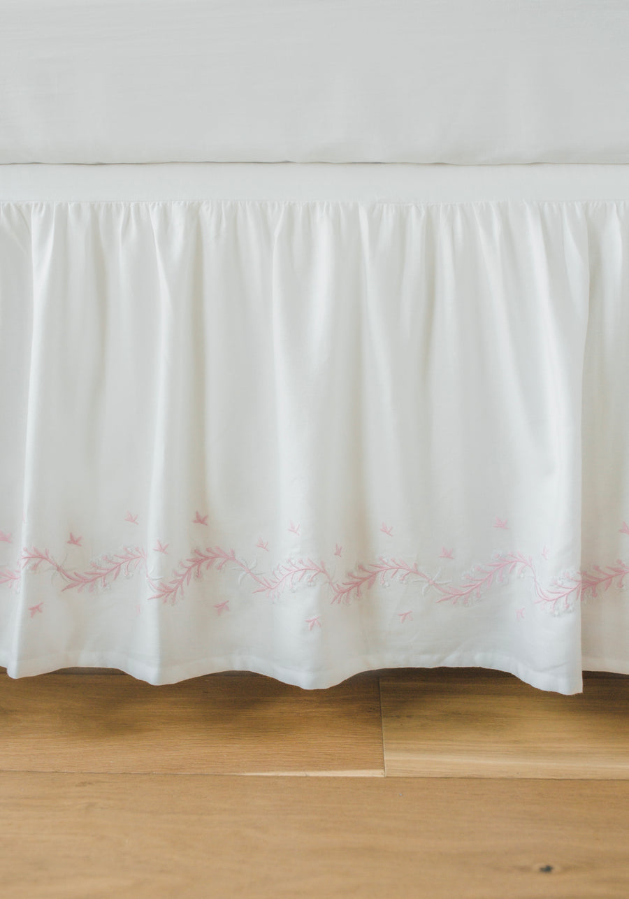 Little English classic nursery goods for baby, white crib skirt with simple light pink embroidery along the edges for baby