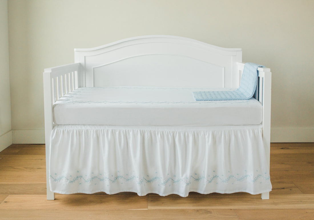 Little English classic nursery goods for baby, white crib skirt with simple light blue embroidery along the edges for baby