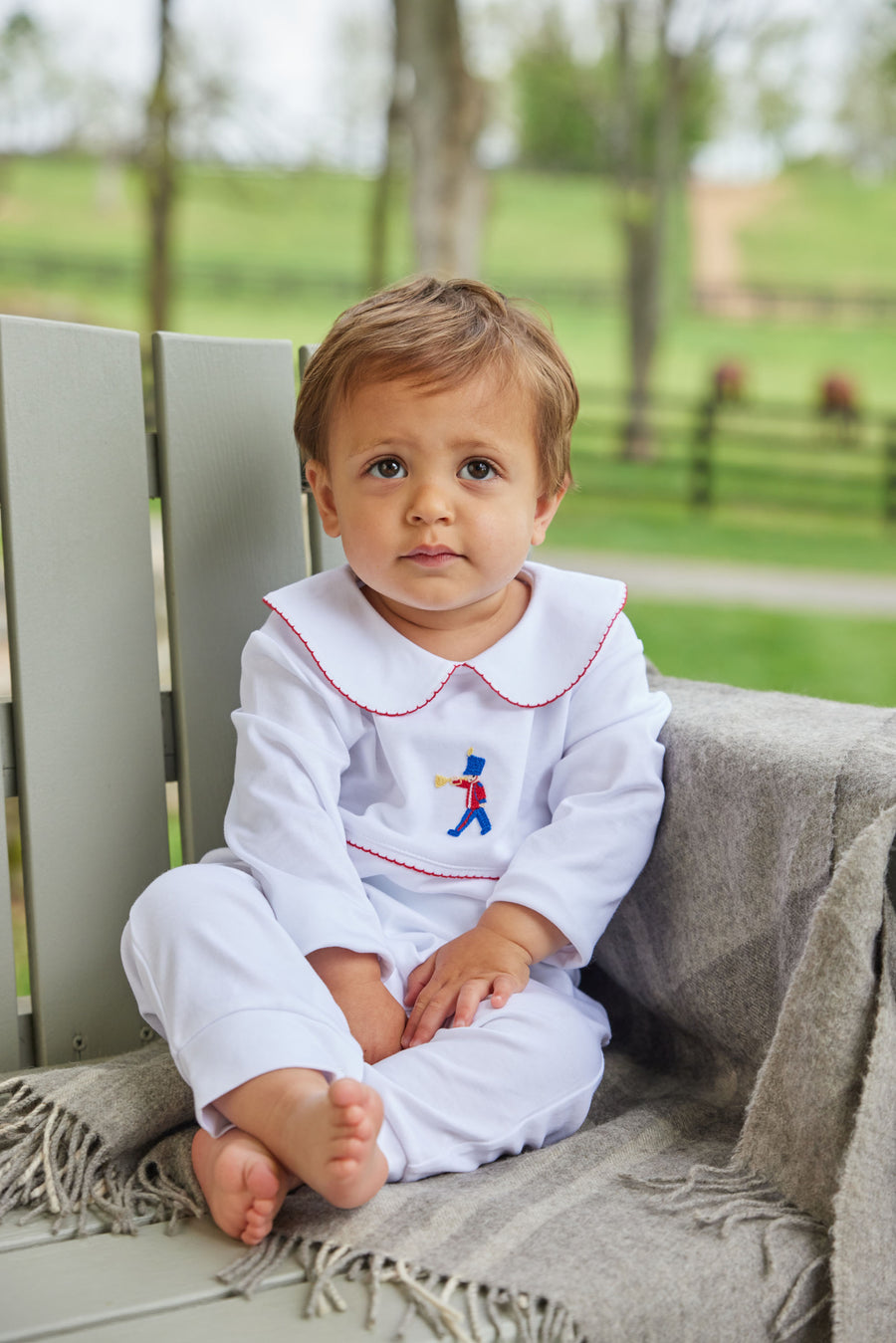 Little English classic baby boys white playsuit with red trim and toy soldier embroidery on chest