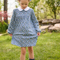 Little English traditional children's clothing. Long sleeve blue and green Winslow Floral cotton knit dress with white peter pan collar and blue piping detail for little girls.