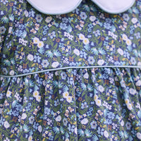 Little English traditional children's clothing. Long sleeve blue and green Winslow Floral cotton knit dress with white peter pan collar and blue piping detail for little girls.