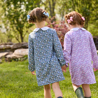 Little English traditional children's clothing. Long sleeve blue and green Winslow Floral cotton knit dress with white peter pan collar and blue piping detail for little girls. Long sleeve pink, blue, and lavender Ashbrook Floral cotton knit dress with white peter pan collar and pink piping detail.