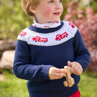 Little English traditional children's clothing. Navy crew neck sweater with red fire truck fair isle detail. Layered over white knit turtleneck with all-over fire truck print. Paired with red corduroy banded pants.  Fall outfit for toddler boys.