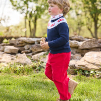 Little English traditional children's clothing. Navy crew neck sweater with red fire truck fair isle detail. Layered over white knit turtleneck with all-over fire truck print. Paired with red corduroy banded pants.  Fall outfit for toddler boys.