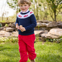 Little English traditional children's clothing. Navy crew neck sweater with red fire truck fair isle detail. Layered over white knit turtleneck with all-over fire truck print. Paired with red corduroy banded pants.  Fall outfit for toddler boys.