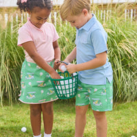 Little English traditional children's clothing.  Classic green twill skort with golf cart print and pink trim for girls.
