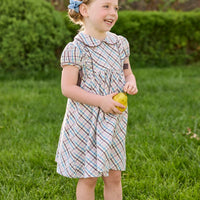 Little English traditional children's clothing. Short sleeve peter pan dress in blue, pink, and brown Wilmington Plaid with brown corduroy piping and bow details for little girls.