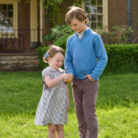 Little English traditional children's clothing. Boys stormy blue quarter zip sweater layered over blue, pink, and brown Wilmington Plaid button down shirt and paired with chocolate brown corduroy classic pants.  Short sleeve peter pan dress in blue, pink, and brown Wilmington Plaid with brown corduroy details for little girls.