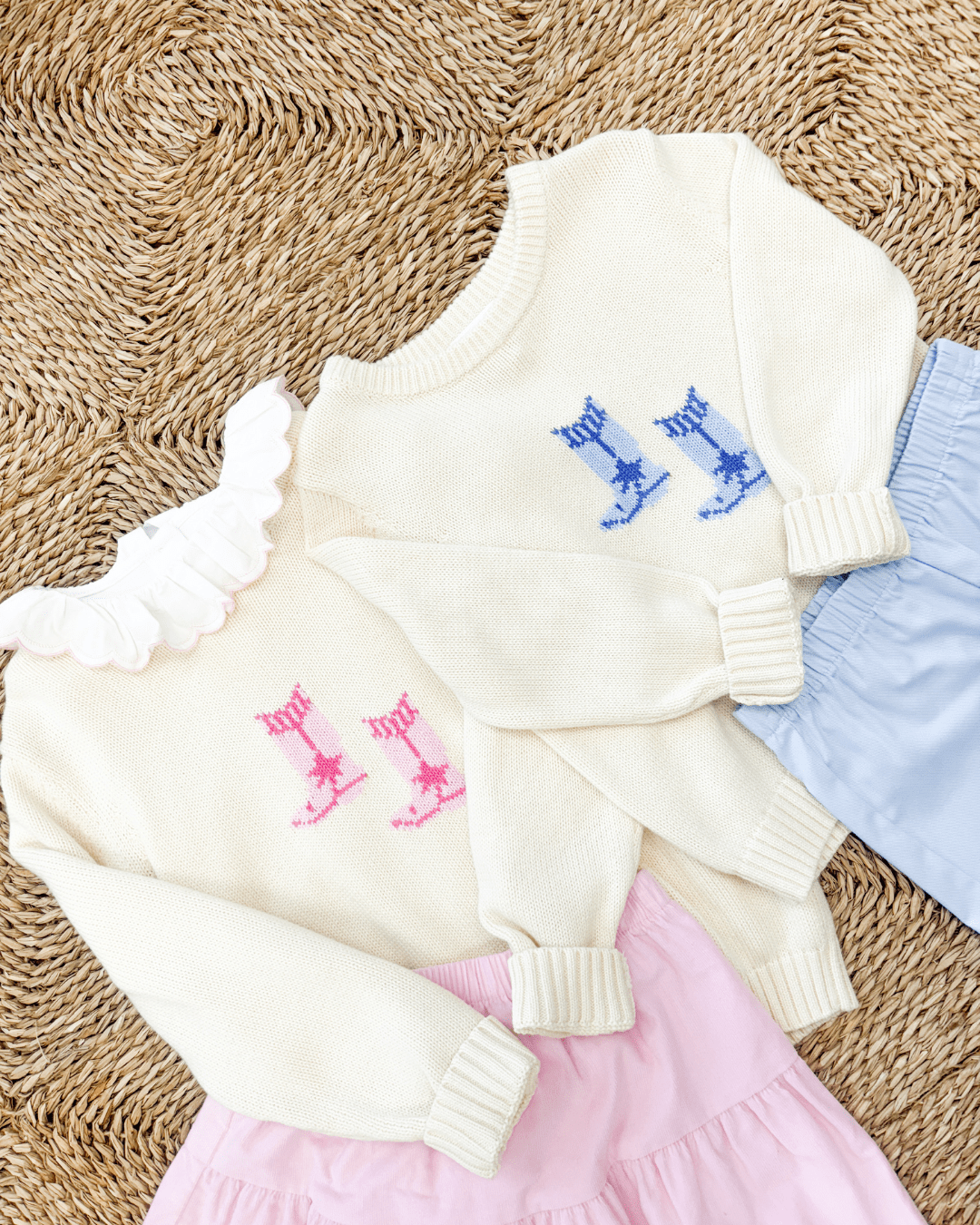 Little English cream intarsia sweaters with cowboy boots in pink and blue