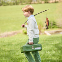 Little English traditional children's clothing.  Boys cream crew neck sweater with fish motif layered over light blue striped polo and paired with watercress green corduroy pants.