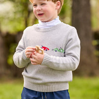 Little English traditional children's clothing.  Grey intarsia sweater with 3 race cars layered over race car print turtleneck and paired with tapered navy sport pants for little boys.