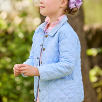 Little English traditional children's clothing.  Long sleeve Hastings polo in light blue with ruffle collar and green floral detailing. Paired with green floral leggings and layered with light blue quilted jacket for little girls.  