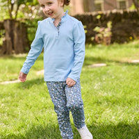 Little English traditional children's clothing.  Long sleeve Hastings polo in light blue with ruffle collar and green floral detailing. Paired with green floral leggings for little girls.  