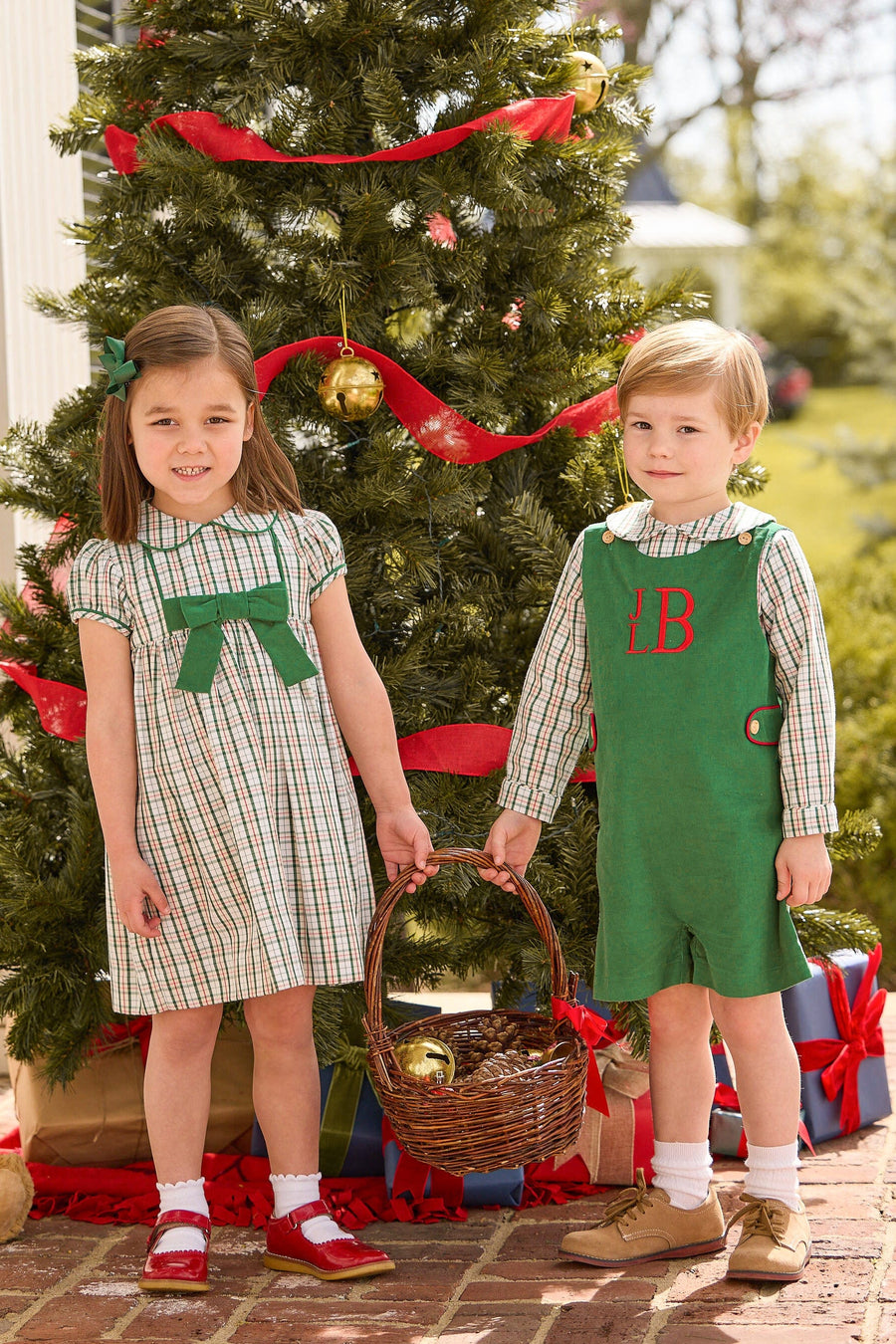 Little English Classic Children's clothing Marisa Dress in mistletoe tartan print with green bow on chest, peter pan shirt in mistletoe tartan, button tab john john in evergreen corduroy, boys and girls winter styles for the holiday season, coordinating outfits