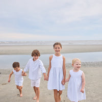 Little English traditional children's clothing.  Light blue and white Savannah Stripe sleeveless dress with white bow tie in back for little girls