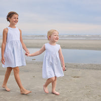 Little English traditional children's clothing.  Light blue and white striped sleeveless dress with white ricrac trim for little girls