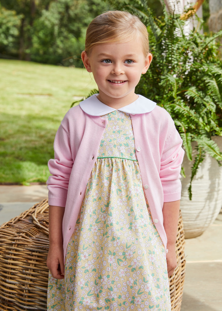 Little English girl's yellow floral spring dress with light pink cardigan