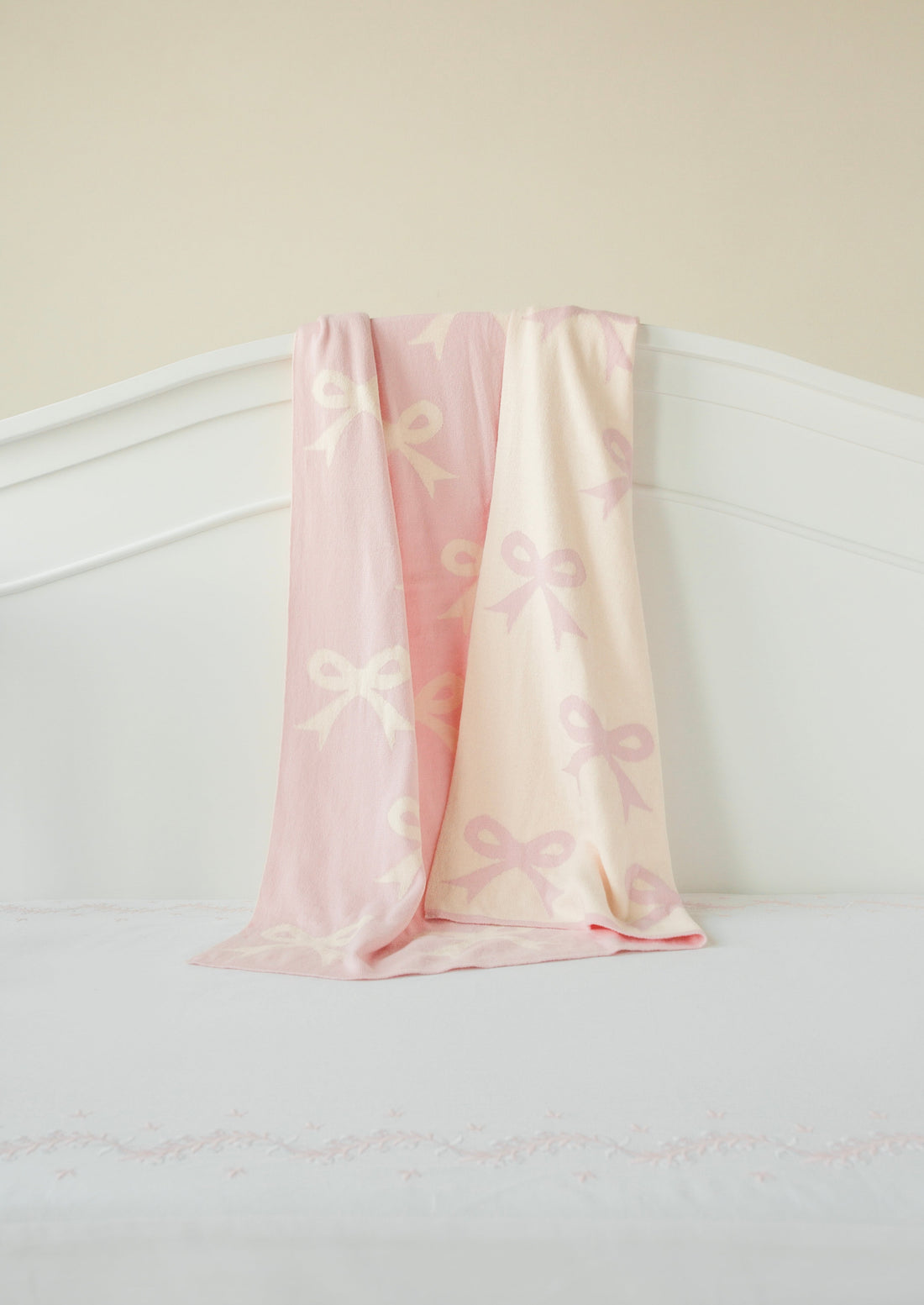 Little English giftable nursery accessory, reversible knit nursery blanket with light pink and cream bow print