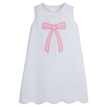 Little English traditional children’s clothing, classic girl's white dress for Spring with piping detail, bow motif in pink vinings print, and scallop hem