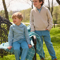 Little English traditional children's clothing.  Classic long sleeve peter pan shirt in blue Alpine Gingham paired with blue Alpine Corduroy pull on pants for toddler boys.  Older boys gray quarter zip sweater layered over blue Alpine Gingham button down shirt and paired with blue Alpine Corduroy classic pants.