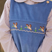 Little English traditional children's clothing.  Khaki Gingham peter pan shirt for toddler boys paired with stormy blue corduroy john john with flying mallard smocking across chest. 