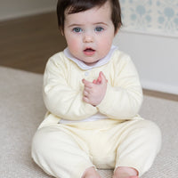 Little English traditional children's clothing. Long sleeve and long pant cream pointelle sweater set accompanied by a picot peter pan onesie in white for baby.