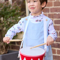 Little English classic children's clothing. White knit turtleneck with holiday train print layered under light blue corduroy Campbell Overall. Holiday outfit for toddler boys.