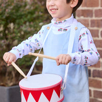 Little English classic children's clothing. White knit turtleneck with holiday train print layered under light blue corduroy Campbell Overall. Holiday outfit for toddler boys.