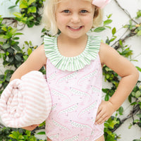 Little English traditional children's clothing. Pink swimsuit with green striped ruffled top and alligator pattern for little girls