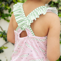 Little English traditional children's clothing. Pink swimsuit with green striped ruffled top and alligator pattern for little girls
