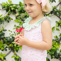 Little English traditional children's clothing. Pink swimsuit with green striped ruffled top and alligator pattern for little girls