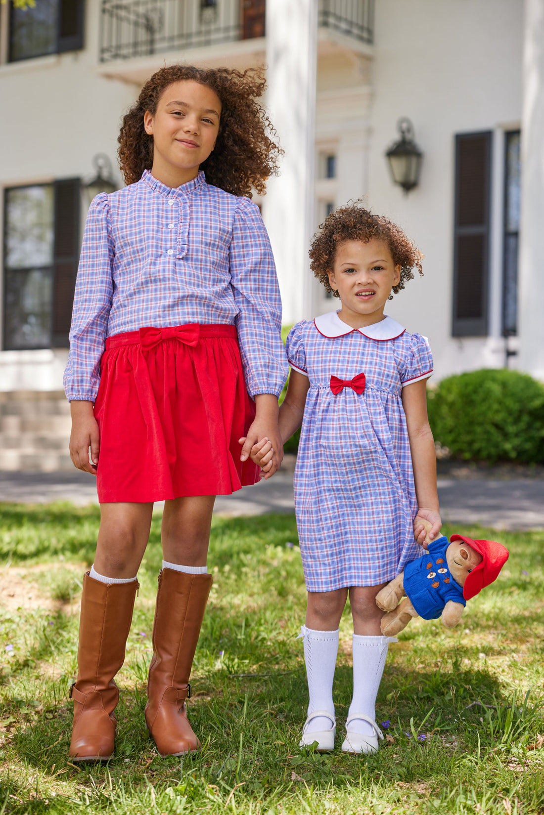 Little English toddler girl traditional red white and blue gingham woven dress with red and white piping