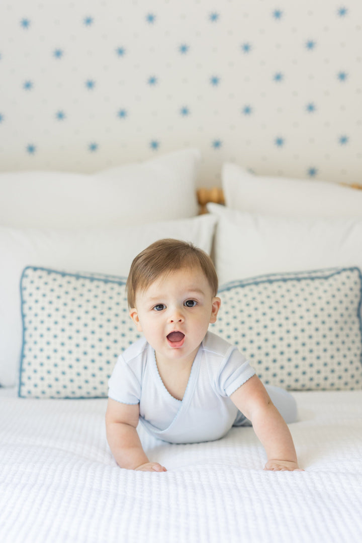 Little English traditional children's clothing. Set of 3 knit onesies in light blue stripe, light blue, and white with light blue stars. Baby jogger set in light blue for baby boys. 