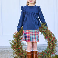 little english classic children's clothing girls navy long sleeve ruffle top with lace detailing a neck and chest, fringe skirt in deep red and navy middleburg plaid, fall outfit for girl