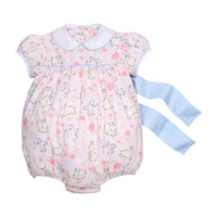 Little English traditional children's clothing.  Classic peter pan bubble with capped sleeves and a light blue sash in a light pink bunny print for baby girls.  Easter outfit for baby girls.