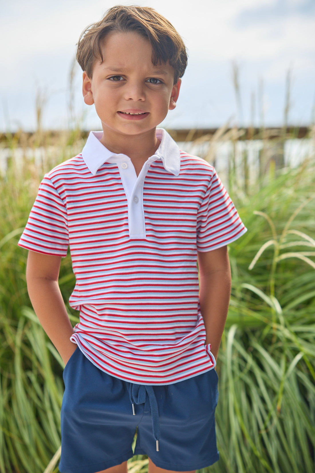 Little English classic short sleeve polo in red, white, and blue americana stripe. Sport short in navy. For little boy 
