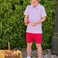 Little English classic children's clothing.  Boys red and blue Primary Stripe short sleeve polo paired with red Sport Short. Back to school outfit for boys.