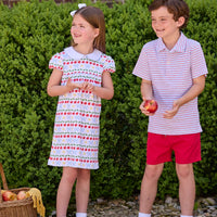Little English classic children's clothing.  Short sleeve white knit peter pan dress with school themed print.  Boys red and blue Primary Stripe short sleeve polo paired with red Sport Short. Back to school outfit for girls and boys.