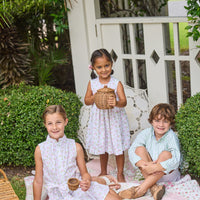 Little English traditional children's clothing.  White sleeveless smocked dress with pink and green florals for little girls