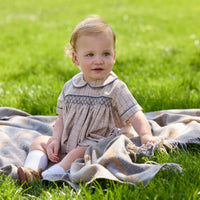 Little English classic children's clothing.  Smocked peter pan bubble in tan and blue Durham windowpane with blue piping for baby boys