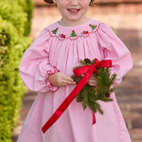 Little English traditional children's clothing.  Long sleeve pink corduroy dress with Christmas motif smocking around the neckline for little girls.