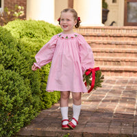 Little English traditional children's clothing.  Long sleeve pink corduroy dress with Christmas motif smocking around the neckline for little girls.