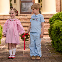 Little English traditional children's clothing.  Long sleeve pink corduroy dress with Christmas motif smocking around the neckline for little girls. Boys blue corduroy set - banded pants paired with Eaton collar short sleeve top with holiday train smocking across the chest.