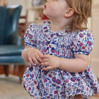 Little English classic childrens clothing baby girl purple red and blue floral bubble with smocking at the chest and ruffled collar