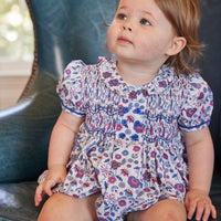 Little English classic childrens clothing baby girl purple red and blue floral bubble with smocking at the chest and ruffled collar