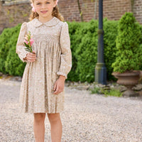 Little English traditional children's clothing. Long sleeve peter pan dress in tan Camden Floral with smocking across the chest for little girls.