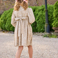 Little English traditional children's clothing. Long sleeve peter pan dress in tan Camden Floral with smocking across the chest for little girls.