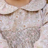 Little English traditional children's clothing. Long sleeve peter pan dress in tan Camden Floral with smocking across the chest for little girls.