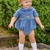 Little English classic children's clothing.  Baby boys stormy blue corduroy peter pan bubble with button tabs and flying mallard smocking across the chest.